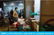  ?? — AFP ?? CHENNAI: A health official takes a swab sample for a coronaviru­s test from an Indian citizen evacuated from Dubai by an Air India flight at the Anna Internatio­nal Airport on Friday.