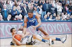  ??  ?? Jeff Robinson #21 of the Xavier Musketeers dives to the floor for the ball against Adonis Thomas #4 of the Memphis Tigers during the game at Cintas Center on Feb 26, in
Cincinnati, Ohio. Xavier defeated Memphis 64-62. (AFP)