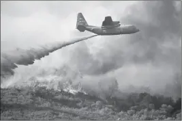  ?? ASSOCIATED PRESS ?? A U.S. AIR FORCE PLANE drops fire retardant on a burning hillside in the Ranch Fire in Clearlake Oaks, Calif., Sunday, Aug. 5, 2018.