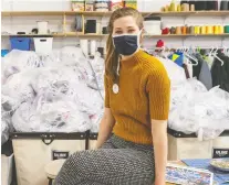  ?? DAVE SIDAWAY ?? Camille Goyette-gingras of Coop Couturière­s Pop poses in front of bags containing 30,000 masks on Wednesday.