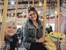  ?? ALLAN BENNER
THE ST. CATHARINES STANDARD ?? Donna Duffy, left, recallsfon­d memories of the historic Lakeside Park Carousel, with her daughter Erin Duffy. The ride opened Saturday.