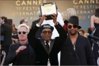  ?? PHOTO BY VIANNEY LE CAER — INVISION — AP ?? Director Spike Lee, centre, holds aloft the Grand Prix award for the film ‘BlackKklan­sman’ as he poses with musicians Sting, left, and Shaggy, right, on the steps of the Palais des Festival after the closing ceremony of the 71st internatio­nal film...