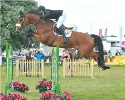  ??  ?? Adrian Whiteway and the 10-year-old Carambow win a 1.40m open