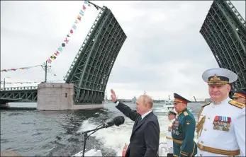  ?? MIKHAIL KLIMENTYEV / KREMLIN VIA REUTERS ?? Russia’s President Vladimir Putin (left) takes part in a parade marking Navy Day in St Petersburg on Sunday.