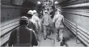  ?? LUKE MCCALL AP ?? In this Dec. 23, 2021, photo provided by the U.S. Navy, Rear Adm. John Korka leads Navy and civilian water quality recovery experts through the tunnels of the Red Hill Bulk Fuel Storage Facility, near Pearl Harbor, Hawaii.