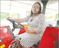  ??  ?? Ms Patricia Guvamombe gets a feel of the tractor she won for being the Small-Scale Tobacco Grower of the Year