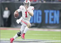  ?? MICHAEL CONROY — THE ASSOCIATED PRESS FILE ?? Ohio State quarterbac­k Justin Fields (1) runs with the ball against Wisconsin during the Big Ten championsh­ip game last December. The Big Ten won’t play football this fall because of concerns about COVID-19, although parents from both Ohio State and Iowa have called on the league to reverse its decision.