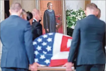  ?? AP- Andrew Harnik ?? The flag-draped casket of Justice Ruth Bader Ginsburg, carried by Supreme Court police officers, arrives in the Great Hall at the Supreme Court in Washington on Wednesday. Ginsburg, 87, died of cancer on Sept. 18.