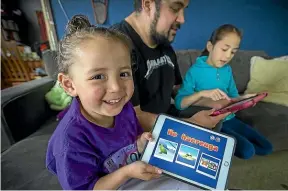  ?? FILE PHOTO/STUFF ?? Whiutaikah­a Tawhai-Porter, 3, with a Mā ori language app. If you want to really learn te reo, you have to fight the incursion of te ao Pākehā into every hour of your life, says Joel Maxwell.