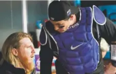  ?? Andy Cross, The Denver Post ?? Rockies catcher Tony Wolters, right, talks with pitcher Jon Gray in the dugout in between innings against the Reds earlier this season at Coors Field. Gray is being recalled from Triple-A and will start Saturday.