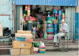  ??  ?? Despondent trader: No sales of plastic ware and polythene items. Pix by Sameera Weeraseker­a