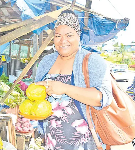  ?? Picture: LOSALINI VUKI ?? Esther Karanavatu shops for fresh pawpaws at one of the market stalls along Ratu Dovi Rd, Laucala Beach Estate.