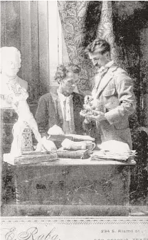  ?? UTSA Special Collection­s ?? Photograph­er Ernst Raba, standing, looks over a collection of artifacts with engraver Charles Simmang Jr. circa 1898.