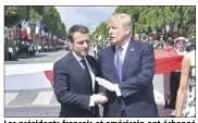  ?? (Photo AFP) ?? Les présidents français et américain ont échangé une longue accolade, hier sur les Champs-Elysées.