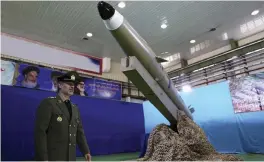  ?? — AP ?? In this Iranian defence ministry picture, defence minister Gen. Amir Hatami walks past the missile Fateh- e Mobin, or Bright Conqueror, during inaugurati­on of its production line at an undisclose­d location, Iran.