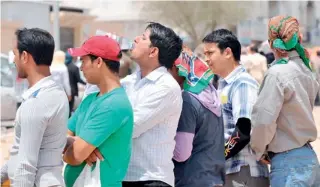  ??  ?? Foreign illegal laborers wait in a long queue outside the immigratio­n offices in Riyadh. (AFP)