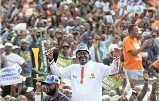  ?? PICTURE: AP ?? Main opposition leader Raila Odinga greets supporters through the sunroof of his vehicle as he arrives for his final electoral campaign rally at Uhuru Park in Nairobi on Saturday.