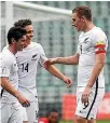  ??  ?? Fleet-footed winger Marco Rojas, left, is congratula­ted by All Whites captain Chris Wood, right, and Ryan Thomas during their win over New Caledonia on Saturday.