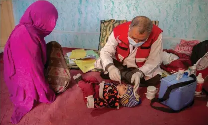  ?? Photograph: Disasters Emergency Committee/PA ?? A child is examined by a doctor from the Afghan Red Crescent mobile health team.