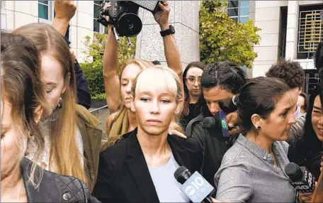  ?? Rich Pedroncell­i Associated Press ?? SHERRI PAPINI leaves the federal courthouse in Sacramento after U.S. District Judge William Shubb sentenced her to 18 months in prison Monday. Federal prosecutor­s had asked that she be sentenced to eight months behind bars for faking her own kidnapping in 2016.