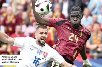  ?? ?? Amadou Onana heads the ball clear against Slovakia.