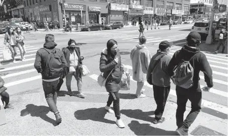  ?? MARK LENNIHAN/AP ?? People on a street last month in the New York metropolit­an area. Roughly 216,000 people moved away from the area in 2020.