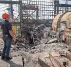  ?? VYACHESLAV MADIYEVSKY­Y/REUTERS ?? An employee of a critical energy facility in Kharkiv, Ukraine, that was recently hit during a Russian missile strike surveys damage on Thursday.