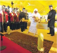  ??  ?? The consort of the late Sultan, Sultanah Haminah Hamidun, sprinkling scented water on his grave at the Langgar Royal Mausoleum in Alor Star yesterday.