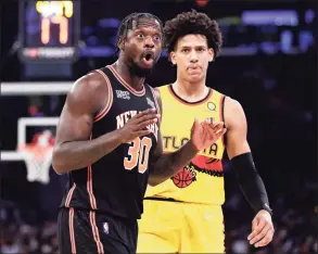  ?? Adam Hunger / Associated Press ?? Knicks forward Julius Randle (30) reacts to a foul call against the Knicks in front of Hawks forward Jalen Johnson on Saturday.