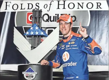  ?? John Amis / The Associated Press ?? Brad Keselowski poses in victory lane after winning Sunday’s Monster Cup series race at Atlanta Motor Speedway.