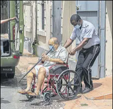  ?? AP ?? Mehul Choksi is taken to a police van by an officer after attending a court hearing in Roseau, Dominica.