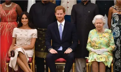  ?? Photograph: John Stillwell/AFP/Getty Images ?? Meghan, Harry and the Queen at an event at Buckingham Palace in June 2018.