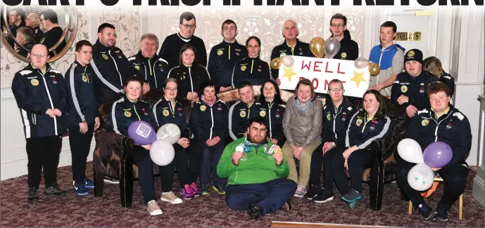  ?? Photo Michelle Cooper Galvin ?? World Special Olympian Gold and Silver Medalist Gary O’Sullivan with members of the Kerry Stars Cliona Palmer, Martina McCarthy, Breda Healy, Anthony O’Connor, Siobhan Looney, Catherine Fleming, John Paul Doyle, Mary Clare McCarthy, Luke Scollard (back from left) Timmy Dan O’Sullivan, Desmond Dreher, Oisin O’Mahony, Denis Guerin, Anne Marie Ladden, Michael O’Leary, Gerard O’Mahony, Jane Curran, Vincent Lacke, Brendan O’Connell, Stephen Brosnan, Jason O’Sullivan and Clare Spillane at his welcome home party in the Dromhall Hotel, Killarney before travelling to Castleisla­nd.