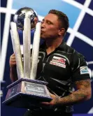  ??  ?? Gerwyn Price kisses the PDC world championsh­ip trophy. Photograph: Luke Walker/ Getty Images