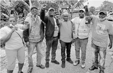  ?? THOMAS PHOTOS BY CHRISTOPHE­R ?? Gregory Clarke (third right), People’s National Party candidate for the Lorrimers division in Trelawny Southern, with supporters outside the office of the returning officer in Albert Town, Trelawny.