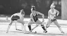  ??  ?? Hereford teammates Emily Endres, left, and Gracie Sanders close in as Kent Island’s Abby Carpenter tries to gain control of the ball at Washington College.