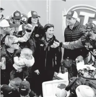  ?? Jerry Markland, Getty Images ?? Clint Bowyer, left, is congratula­ted in Victory Lane by Martin Truex Jr., right, after winning the weather-delayed STP 500 on Monday.