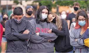  ?? JANE PHILLIPS/FOR THE NEW MEXICAN ?? ABOVE: From left, Chris McKnight, 20; Angel Gonzales, 17; Emily Lopez, 18; and Ashley Martinez, 19, attend an Aug. 2 vigil on the Plaza for Fedonta ‘JB’ White. White died of a gunshot wound Aug. 1.