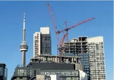  ?? FRANK GUNN/ THE CANADIAN PRESS ?? Constructi­on cranes are seen in Toronto on July 5, 2017.