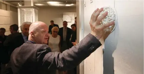  ?? STEVE RUSSELL PHOTOS/TORONTO STAR ?? University of Waterloo professor Robert Jan van Pelt shows the cage to protect the peep hole in an Auschwitz gas chamber.