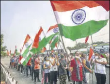  ?? WASEEM ANDRABI/HT PHOTO & PTI ?? PDP president Mehbooba Mufti leads a protest march; BJP workers and supporters celebrate on the 2nd anniversar­y of revocation of Article 370 in Srinagar on Thursday.