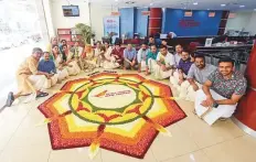  ?? Ahmed Ramzan/Gulf News ?? Staff members at Air India’s Sharjah branch celebrate with traditiona­l ‘pookkalam’ yesterday.