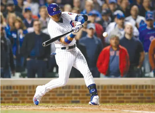  ?? AP ?? Albert Almora Jr. hits a walk-off single with two outs in the 10th inning Wednesday against the Pirates. The Cubs clinched their fourth consecutiv­e playoff appearance.