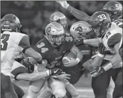  ?? Submitted photo ?? BISONS RUN: Harding running back Cole Chancey (34) fights for yards against the Ouachita Baptist defense a week ago during the Bisons’ 7-3 loss to the Tigers in Searcy. Photo by Jeff Montgomery, courtesy of Harding University Athletics.