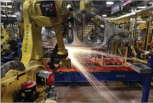  ?? PAUL SANCYA — THE ASSOCIATED PRESS ?? Robots weld a Chevrolet Sonic at the General Motors Orion Assembly plant in Orion Township, Mich., in 2011. General Motors, Ford, jet engine maker Rolls-Royce and other companies are talking to their government­s about repurposin­g idled factories to produce vital goods to fight the coronaviru­s such as ventilator­s and surgical masks.