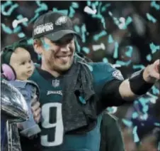  ?? FRANK FRANKLIN II — THE ASSOCIATED PRESS ?? Philadelph­ia Eagles’ Nick Foles holds his daughter, Lily, after beating the New England Patriots in the NFL Super Bowl 52 football game Sunday in Minneapoli­s.
