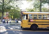  ?? Tyler Sizemore / Hearst Connecticu­t Media ?? A school bus picks up students during dismissal at Old Greenwich School in Old Greenwich on Sept. 23.