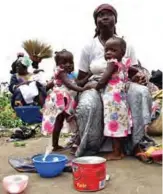  ??  ?? Twin sisters and their mother beg in a market in Abobo.