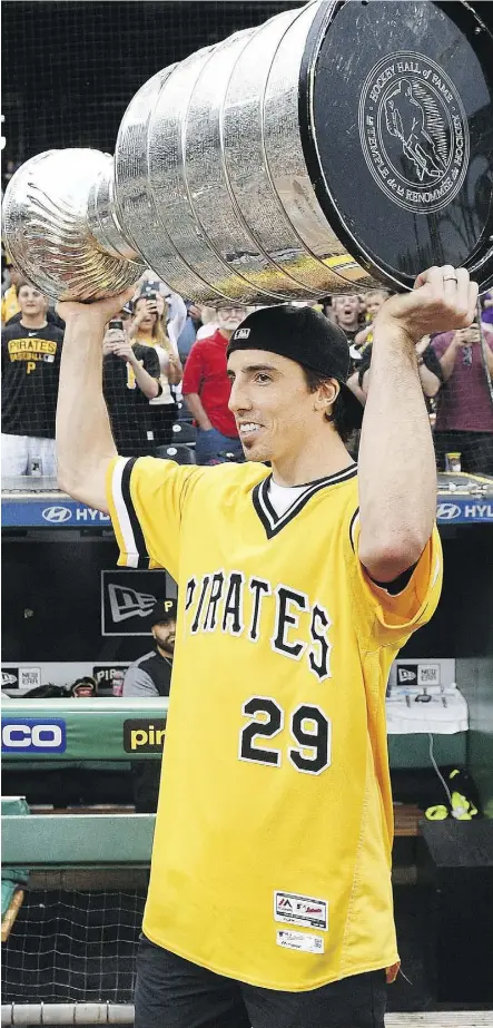  ?? JUSTIN BERL/GETTY IMAGES ?? Penguins goalie Marc-Andre Fleury, celebratin­g with the Stanley Cup at a Pittsburgh Pirates game at PNC Park on Tuesday, is one of the players who will likely be on the move soon to another club.