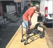  ?? EVAN BRANDT — MEDIANEWS GROUP ?? Walnut Street resident Darryl Awer puts part of a basement pump to the curb Wednesday after his basement flooded for the fourth time in 32 years.